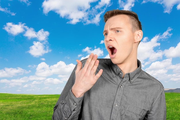 Free photo tired sleepy young man yawning