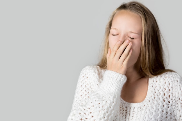 Tired teen yawning