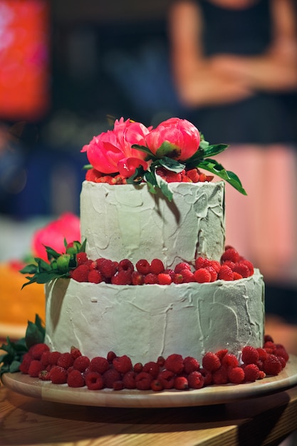 Tired wedding cake decorated with raspberries