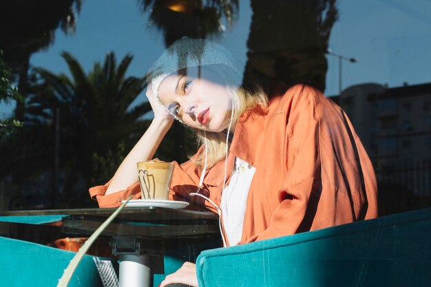 Tired woman sitting in cafe