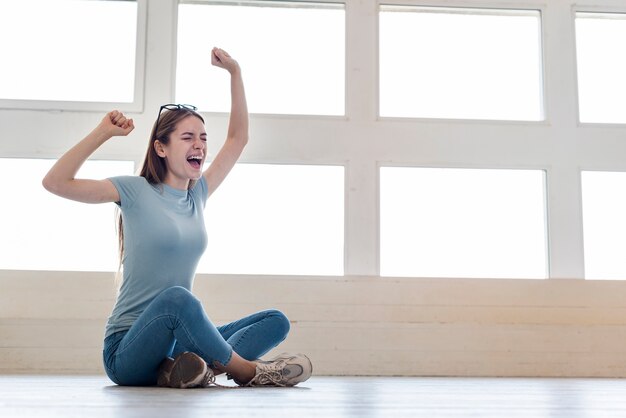 Tired woman stretching on the floor