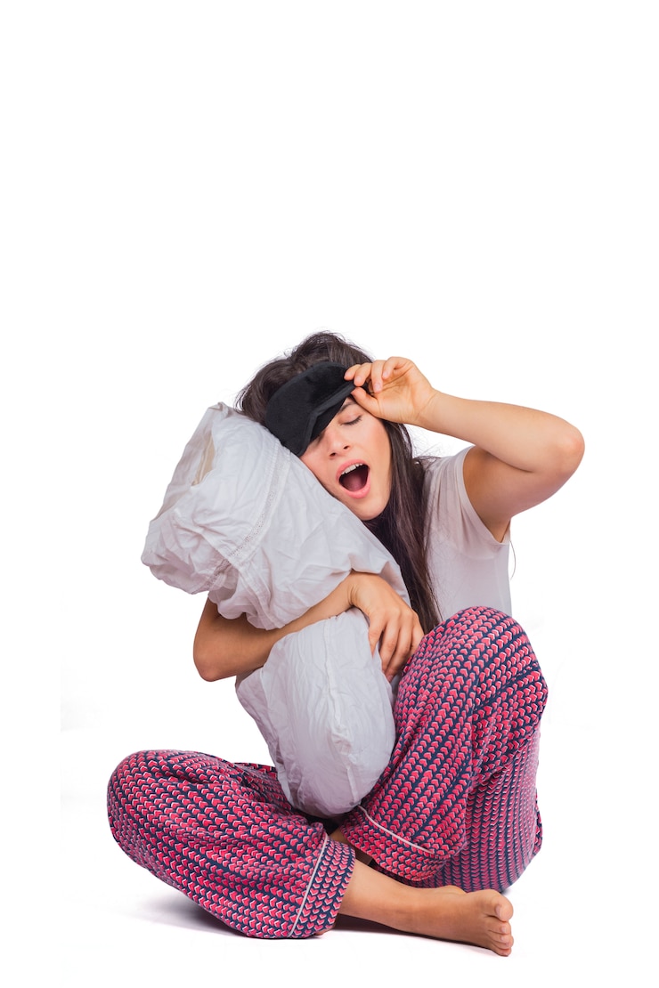 Free Photo tired woman wearing sleep mask, pajama and holding pillow.