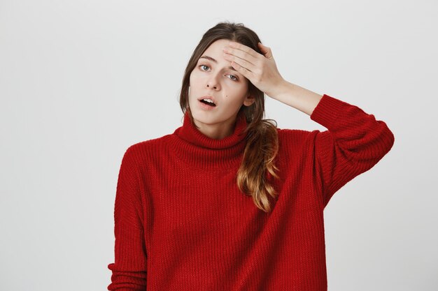 Tired woman wiping sweat from forehead