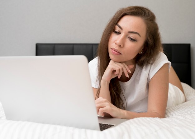 Tired woman working in bed