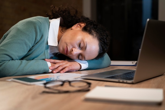 Free photo tired woman working late for a deadline