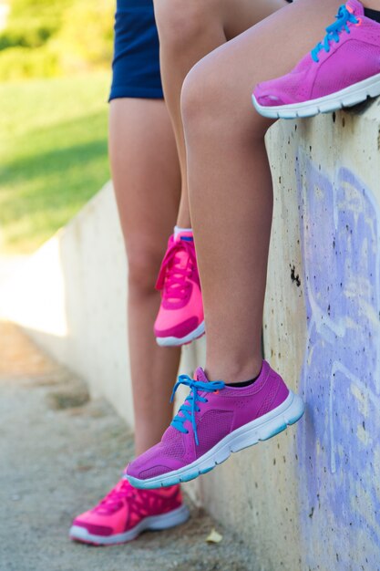 Tired women runner taking a rest after running hard in the park.