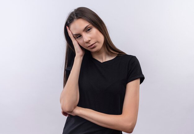 Tired young caucasian girl wearing black t-shirt put her hand on cheek on isolated white