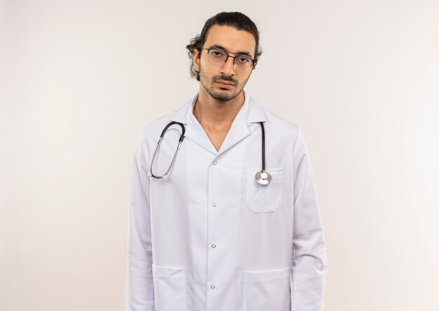tired young male doctor with optical glasses wearing white robe with stethoscope