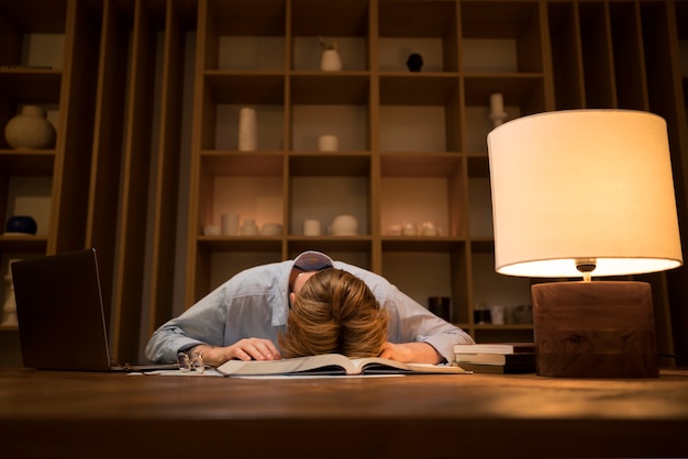 Free photo tired young man learning in a virtual classroom