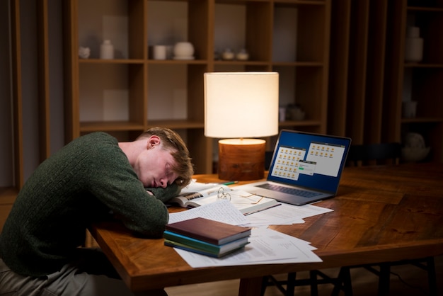 Free photo tired young man learning in a virtual classroom