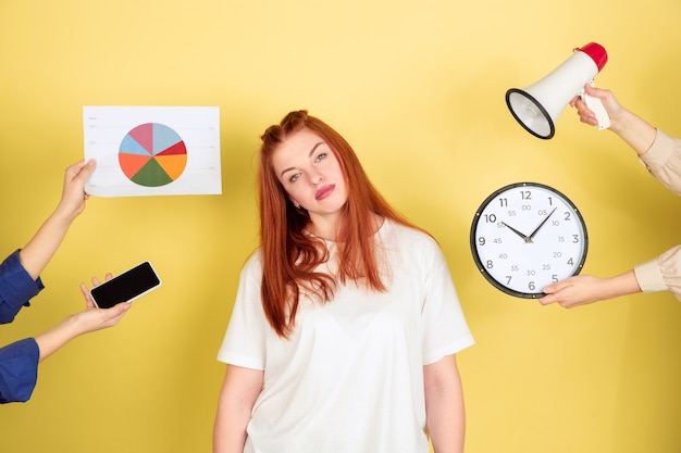 Tired young woman choosing what to do with her time