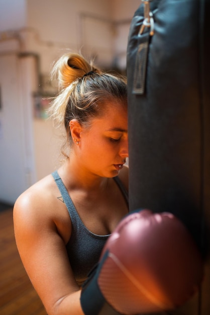 Tired young woman at kickboxing training