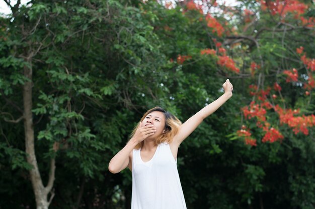 Tired young woman stretching her arms