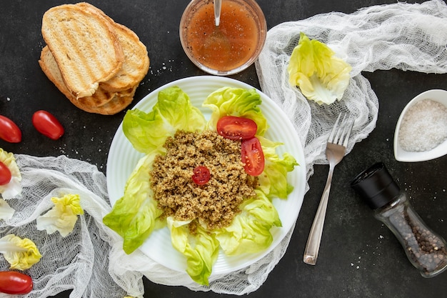 Toast bread with plate with salad and tomatoes