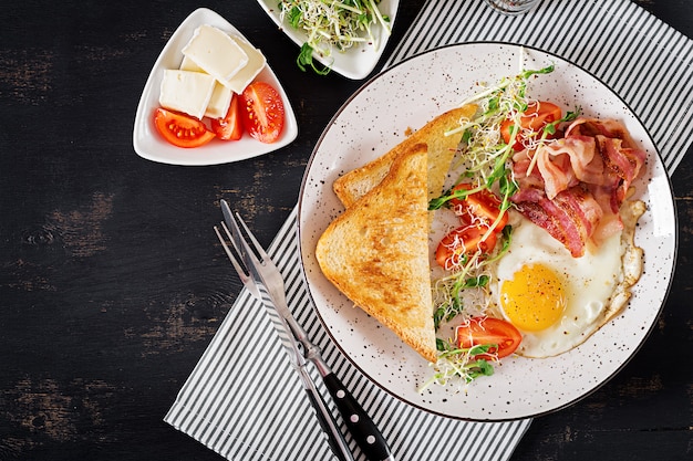 toast, egg, bacon and tomatoes and microgreens salad