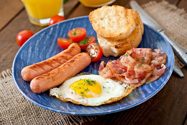 Toast, egg, bacon and vegetables in a rustic style on wooden surface