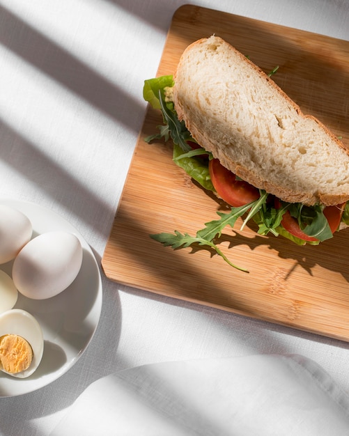 Toast sandwich with tomatoes, greens and hard-boiled eggs