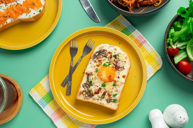 toast with fried egg and cream cheese on pastel green background