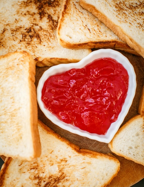 Toast with strawberry jam in a heart shape valentine's day