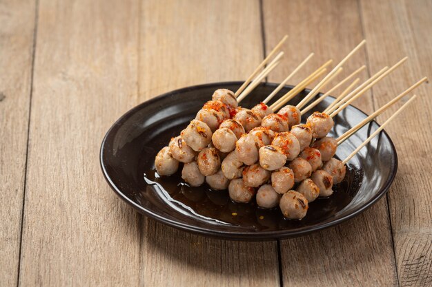 Toasted meatballs topped with spicy sauce