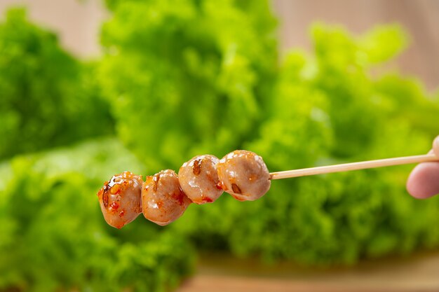 Toasted meatballs topped with spicy sauce