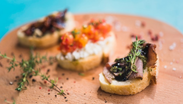 Toasted sandwiches with thyme on wooden chopping board