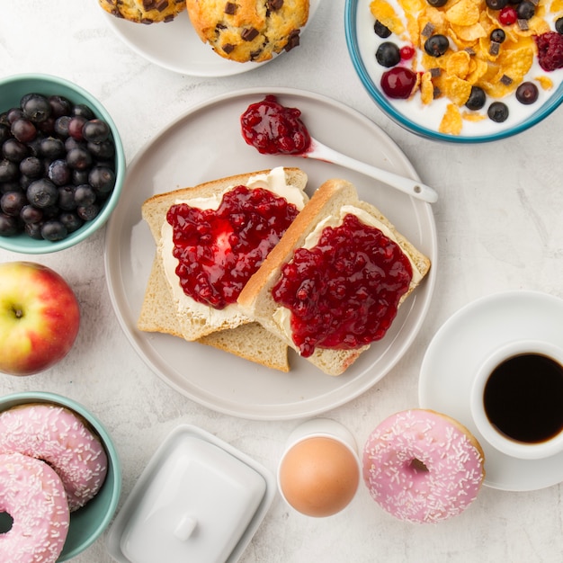 Toasts with jam and spoon on plate