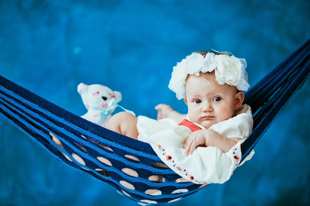 "Toddler girl lying in hammock"