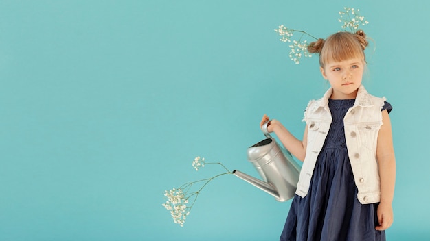 Free photo toddler holding watering can copy space