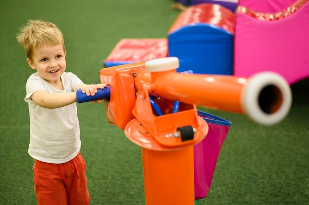 Toddler playing with ball shooter