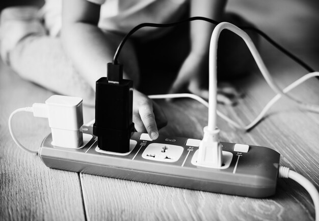 Toddler playing with a plug