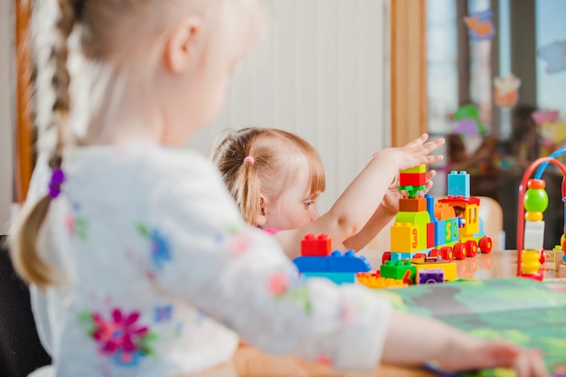 Toddler playing with toy constructor