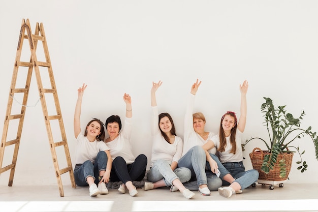 Free photo togetherness group of women with hands in the air