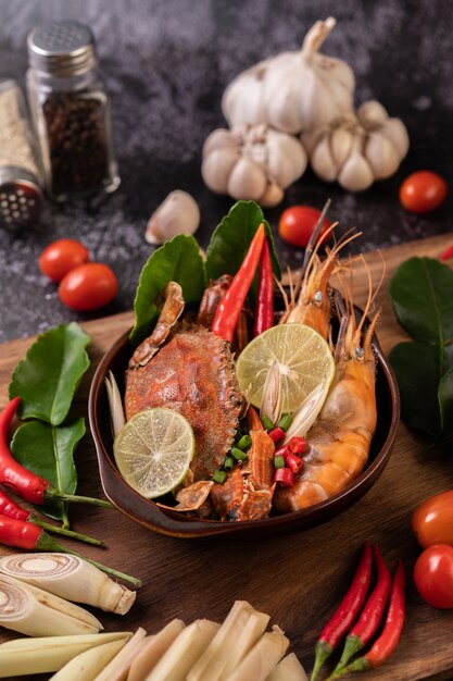 Tom yum with shrimp and crab with lime, chili, tomato, garlic, lemongrass and kaffir lime leaves.