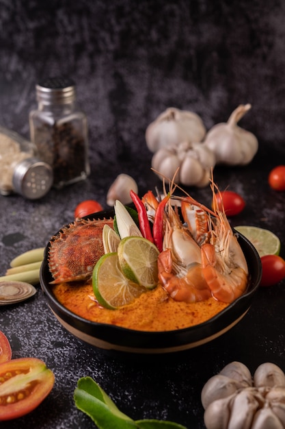 Tom yum with shrimp and crab with lime, chili, tomato, garlic, lemongrass and kaffir lime leaves.