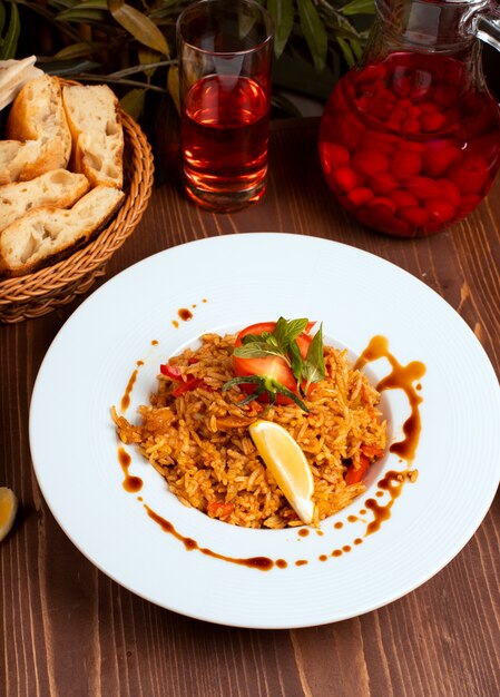 Tomato curry sauce risotto with herbs and vegetables, lemon. 