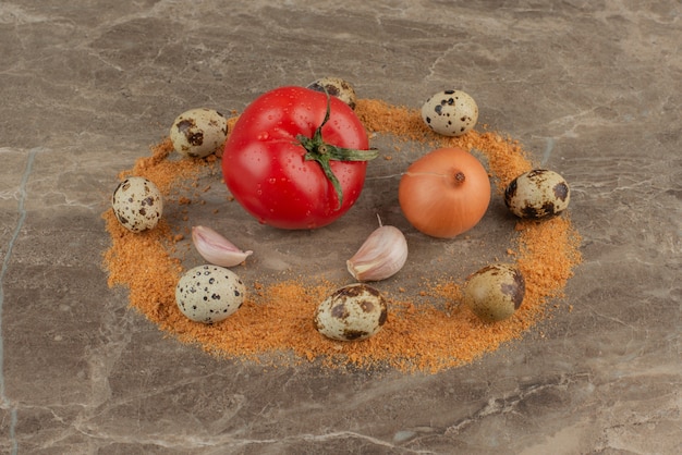 Tomato, onion, garlics, quail eggs and crumbs .