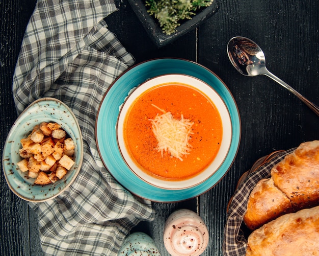 tomato soup topped with cheese 