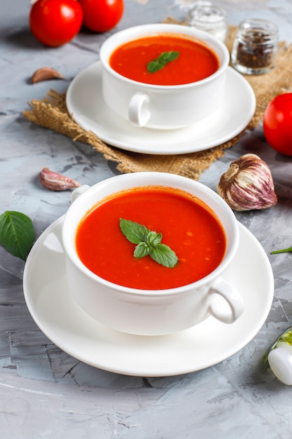 Tomato soup with basil in a bowl.