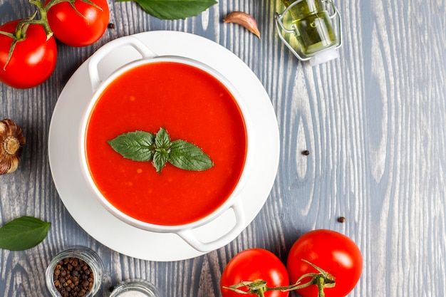 Free photo tomato soup with basil in a bowl.