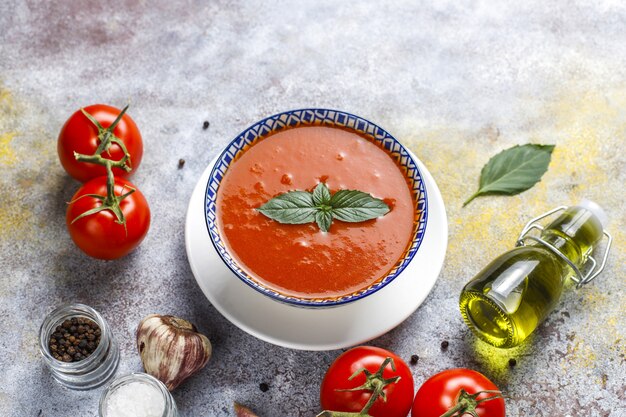 Tomato soup with basil in a bowl.