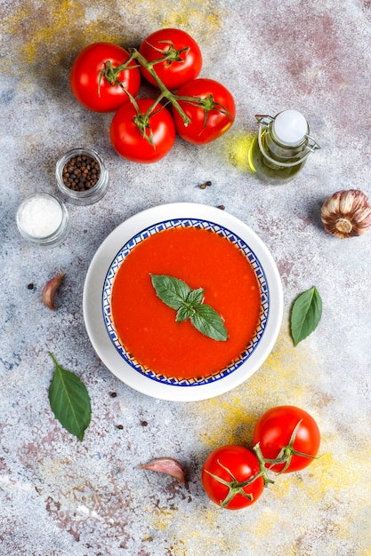 Free photo tomato soup with basil in a bowl.