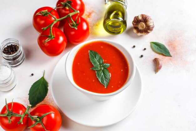 Tomato soup with basil in a bowl.