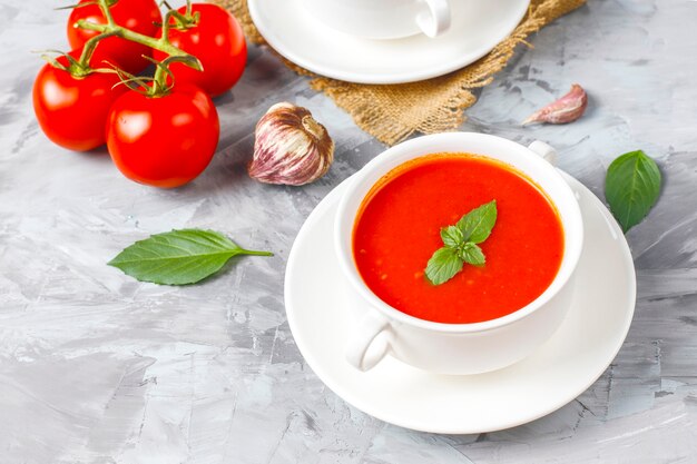 Tomato soup with basil in a bowl.