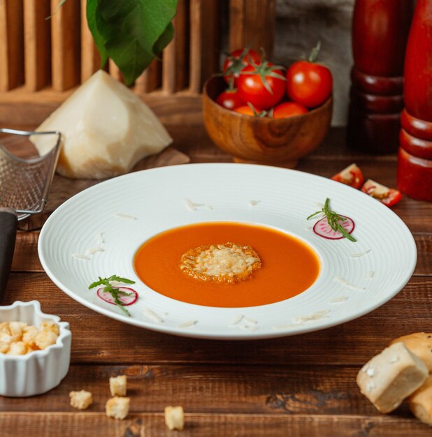 Tomato soup with cheese on the table