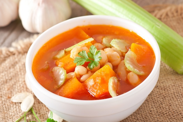 Tomato soup with pumpkin, beans and celery