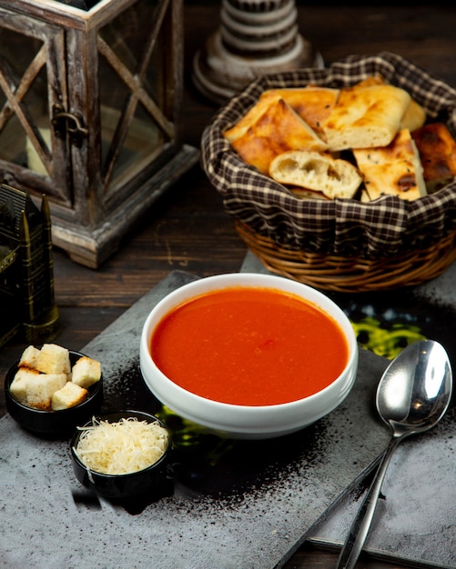 Tomato soup with side crackers and cheese
