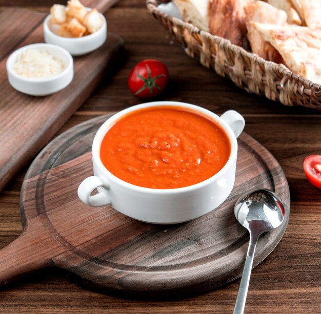 Tomato soup on wooden board