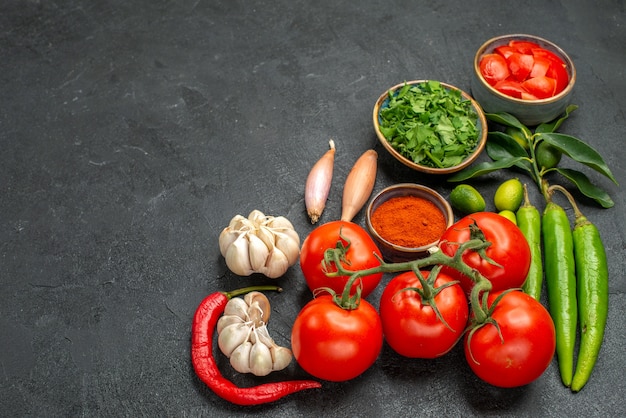 tomatoes bowls of hot peppers tomatoes onions garlic spices herbs