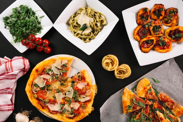 Tomatoes and raw pasta near Italian food